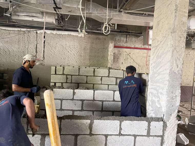 Masons laying blockwork
